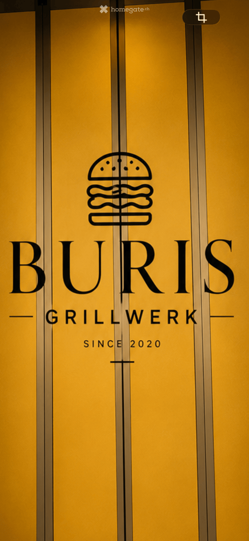 Elevator doors with a logo and text reading "BURIS GRILLWERK SINCE 2020" and a burger icon.