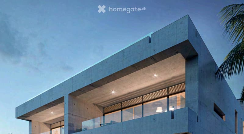 Modern, multi-story concrete building with large glass windows and balconies, featuring clean lines and a contemporary design.