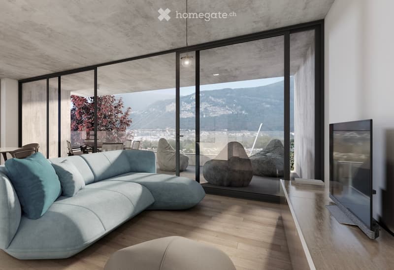 Modern living room with large glass windows offering a scenic mountain view, featuring a light blue sectional sofa, bean bags, a dining table with chairs, and a flat-screen TV.