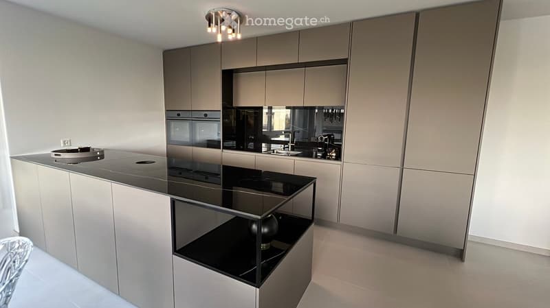 central island with glass countertop, built-in oven and dishwasher, modern cabinets, white tiled floor, pendant lighting