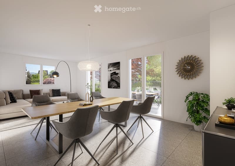 Modern living room with a large wooden dining table, grey chairs, a beige sofa, floor lamp, wall clock, and plants. Large windows and sliding glass doors lead to a balcony.