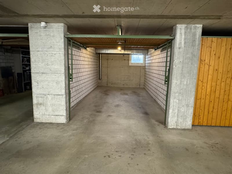 {"type": "Garage", "objects": [], "description": "Empty underground garage with concrete walls, floor, and ceiling. Features a wooden door on the right and a small window at the far end.", "localized_descriptions": {"EN": "Empty underground garage with co