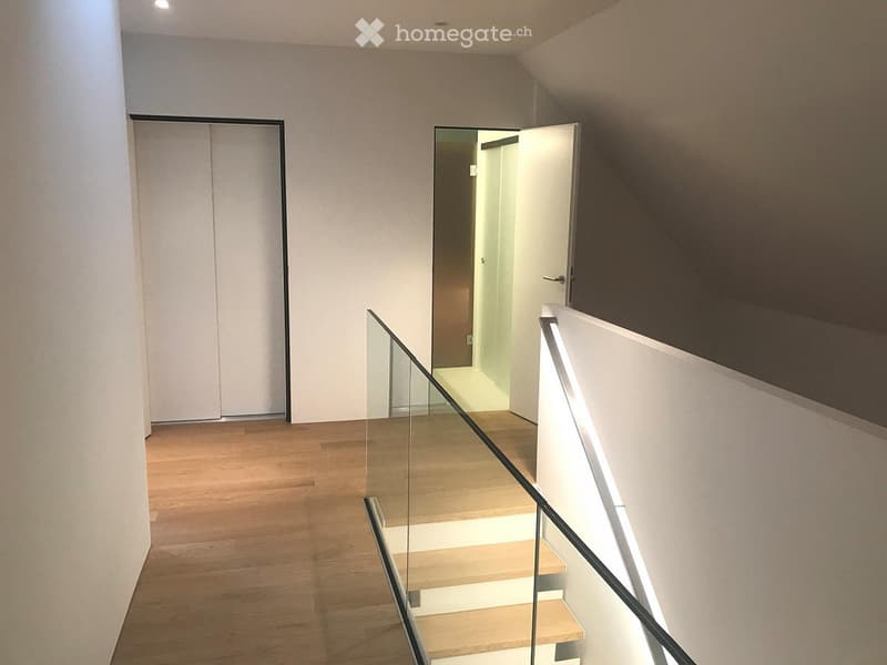 Glass railing, wooden floor, two sets of double doors