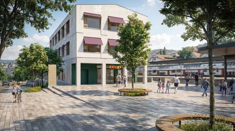 Modern building with a 'Coop' storefront, surrounded by trees and a paved area with benches and people walking.