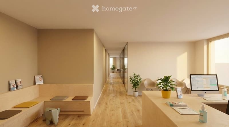 Modern office space with light wood flooring, a desk with a laptop, a chair, a potted plant, and a small stool. The area features a bench with framed pictures and a small plant on a side table.