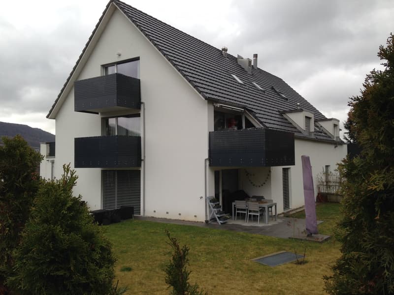 3 story house, white exterior, black roofs, balconies, black exterior wall