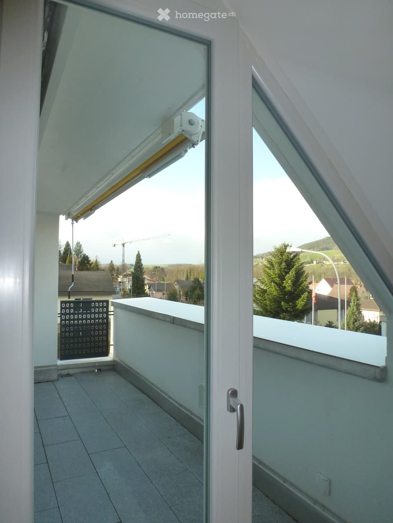 sliding doors, tiled floor, outside balcony with metal railing, view of houses and trees