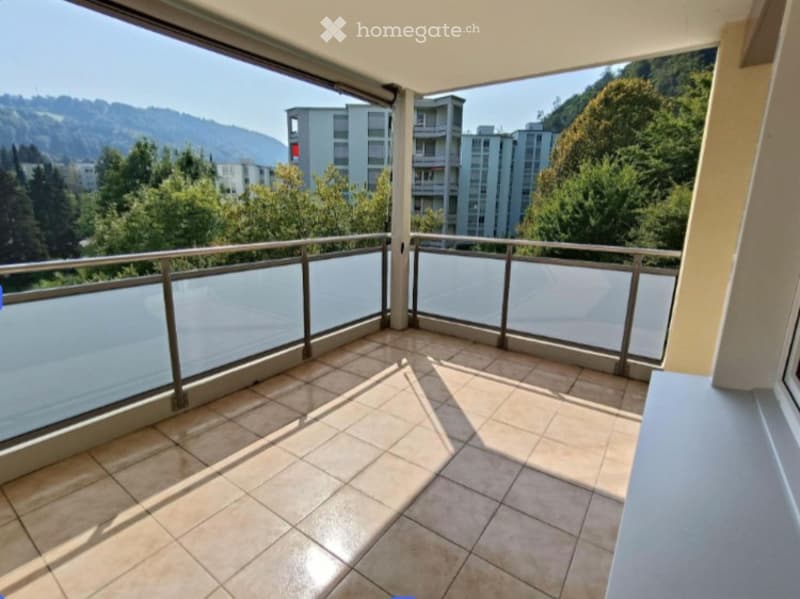 tiled floor, large windows, balcony, metal railings, view of the city