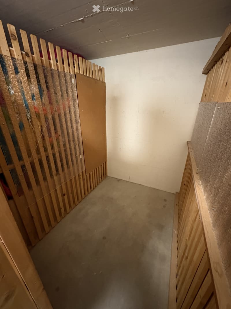 Empty room with wooden walls and floor, white walls, concrete floor
