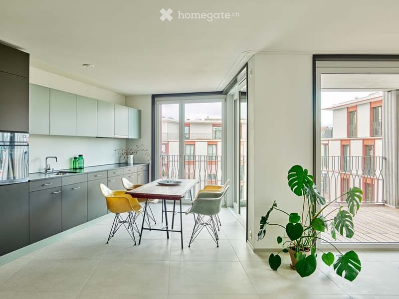 modern kitchen with dining area, large windows, balcony, wooden table, yellow chairs, potted plant