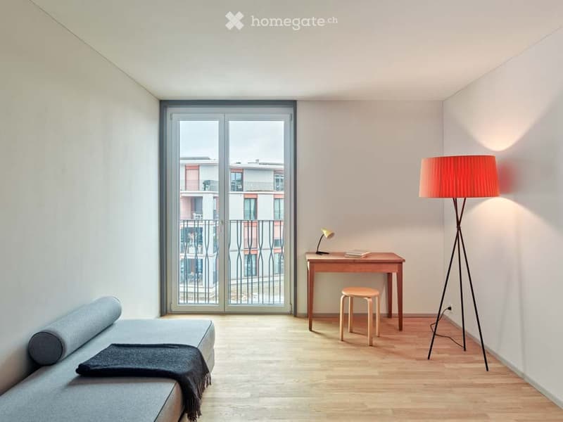 minimalist room with a couch, desk, lamp, stool, floor lamp, and a balcony