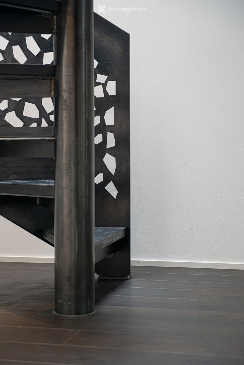 Black metal shelving unit with geometric cutout patterns on the sides