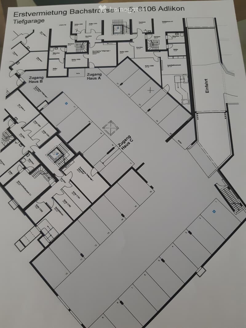 Floor plan of a multi-building complex with labeled rooms, corridors, and entrances, including a deep garage and access points for three houses.