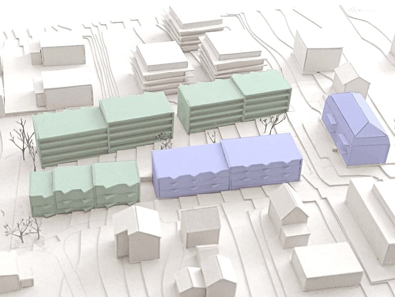 Multiple building structures of varying colors and sizes are shown, with different configurations