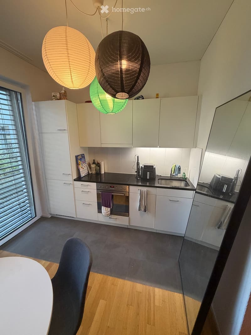 modern design, white cabinets, gray tiled floor, glass window, large mirrors, black countertop, hanging paper lamps