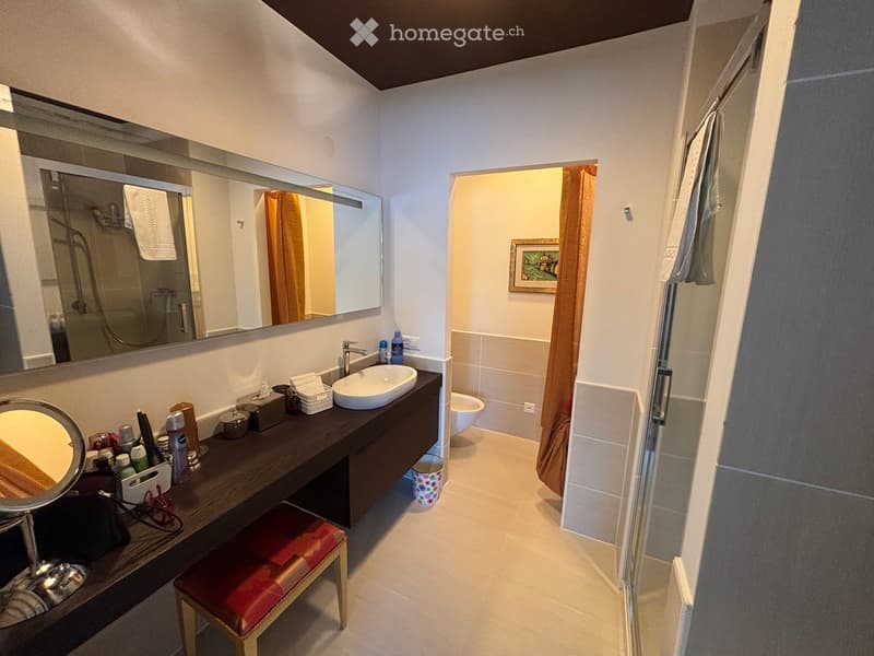 modern bathroom with white walls, white sink, mirror, toilet, shower and frame