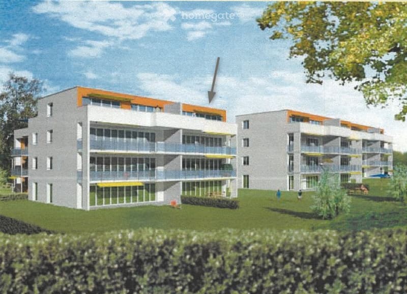 A modern multi-story residential building with balconies and orange accents, surrounded by green lawn and trees.