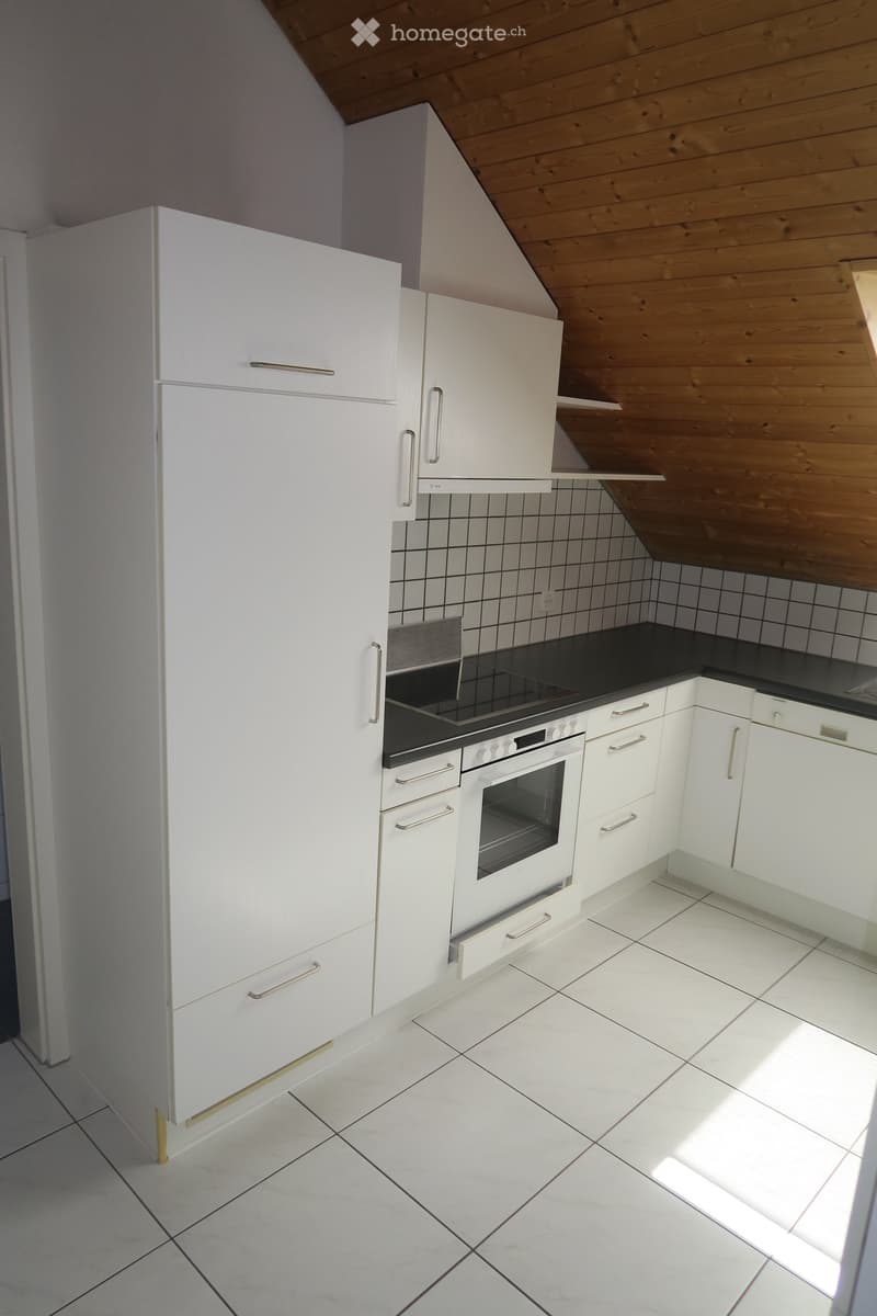 white kitchen cabinets, stainless steel appliances, tile flooring, wooden ceiling, large window