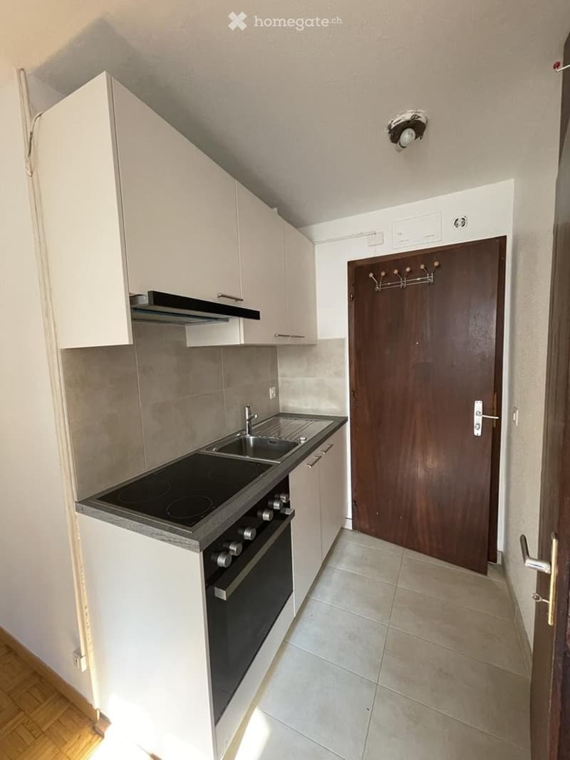 modern kitchen with gas stove, oven, dishwasher, sink, cabinets and tiles