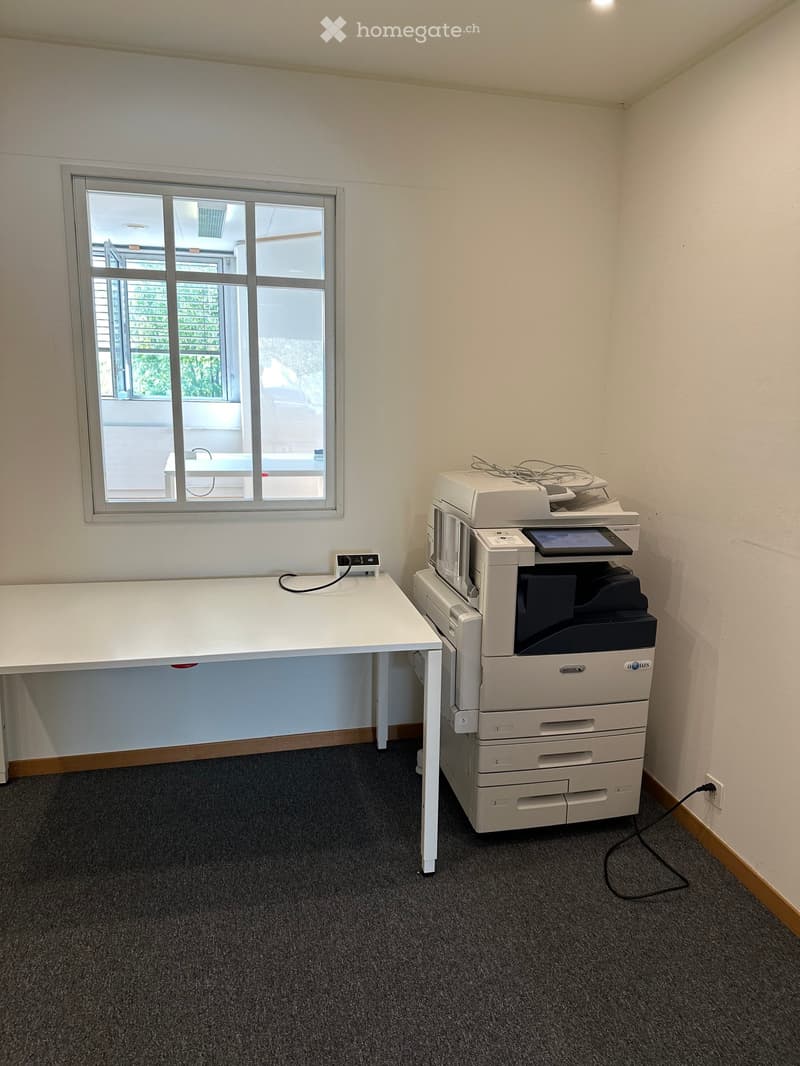 Empty room with window, table and printer