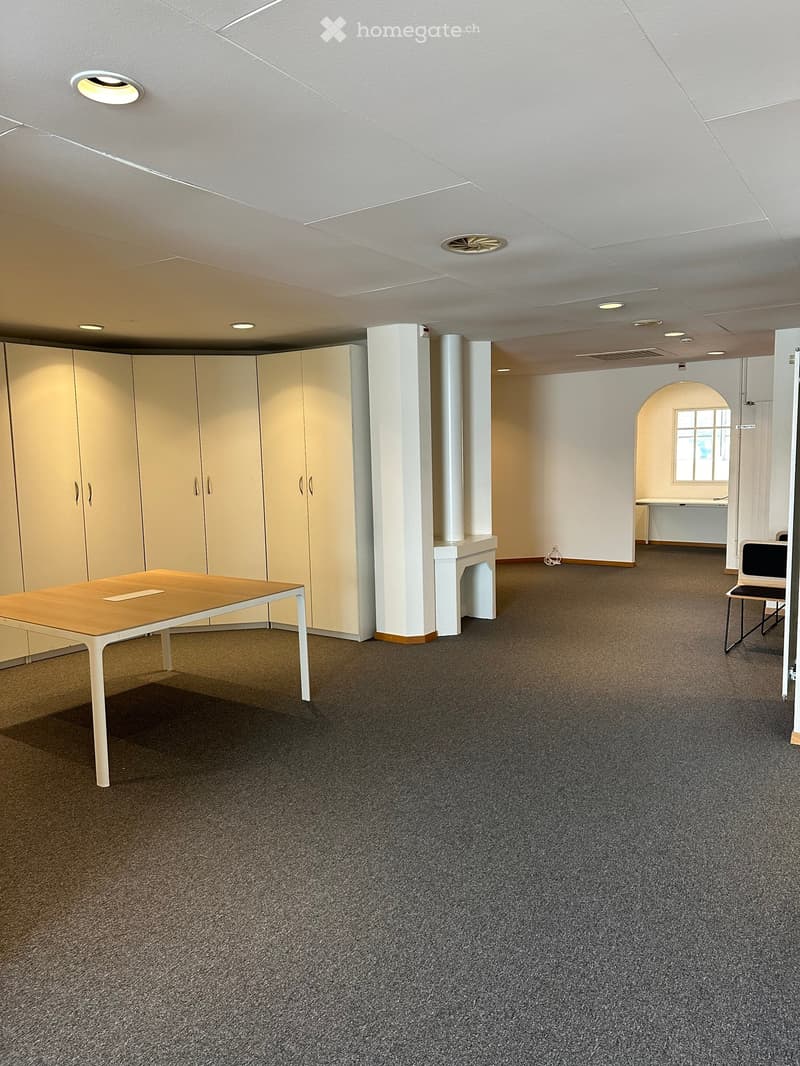 Open room, central heating, large windows, desk, white shelves, chair, carpet