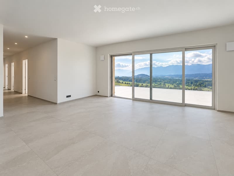 Empty room with large sliding glass doors leading to a balcony, tiled floor, and white walls.