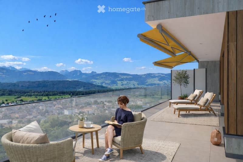 A modern balcony with a panoramic mountain view, featuring a wicker chair, small table with a cup and book, lounge chairs, and a potted plant.