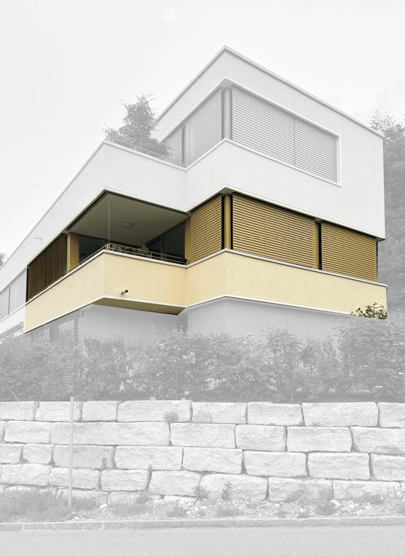Modern two-story building with white and beige facade, large windows, and a prominent balcony on the upper level.