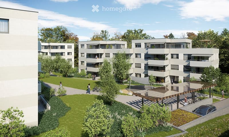 white apartments, 2 story, balconies, paved driveway, large grass lawn, several trees, parking shelter