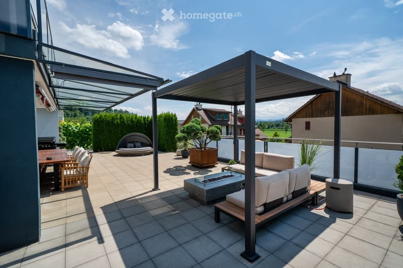 large covered terrace with modern outdoor furniture, plants, fire pit, grill, tiled floor, scenic view