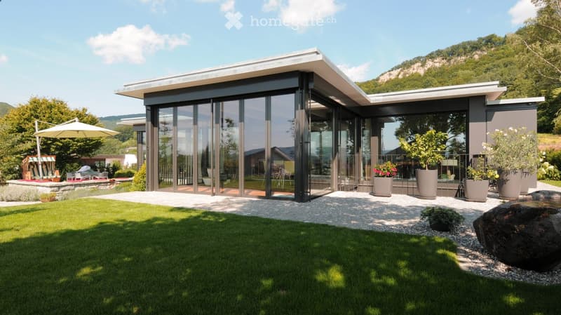 Modern house with large glass windows, gray exterior, large balcony, garden with plants and trees