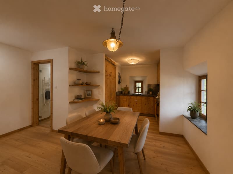 A modern dining area with a wooden dining table and chairs, shelves with decorative items, and an open kitchen area with cabinets and a sink.