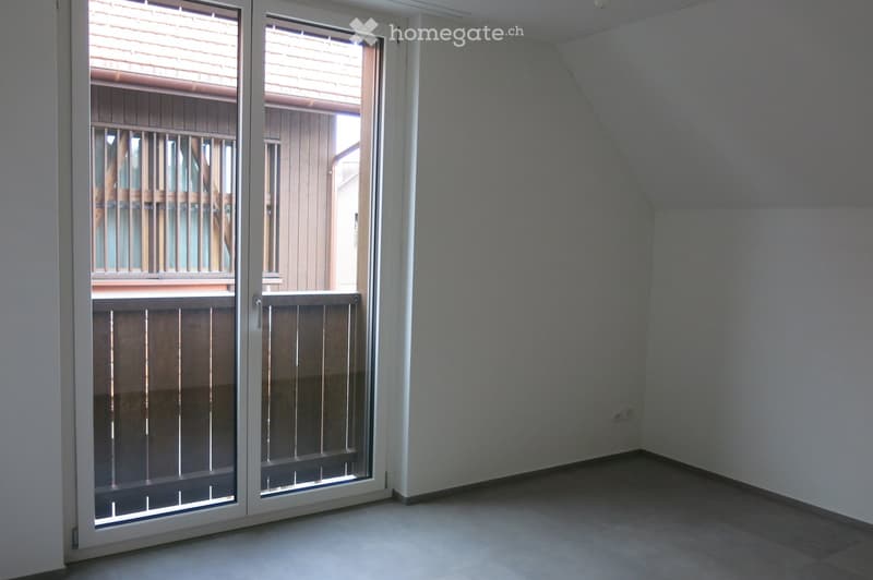 empty room, sliding glass door, balcony, white walls, gray floor