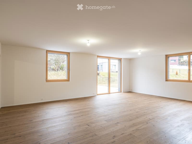 Empty room, hardwood floors, white walls, large windows, sliding glass door