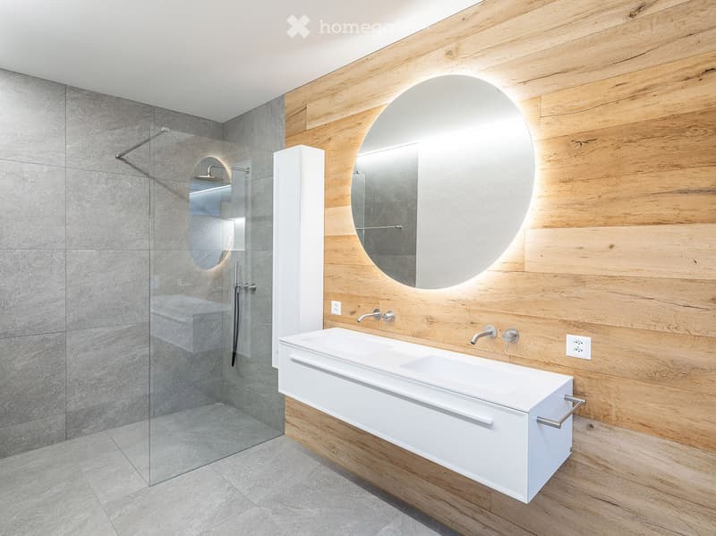 modern bathroom, gray tiles, white sink, large mirror, glass shower
