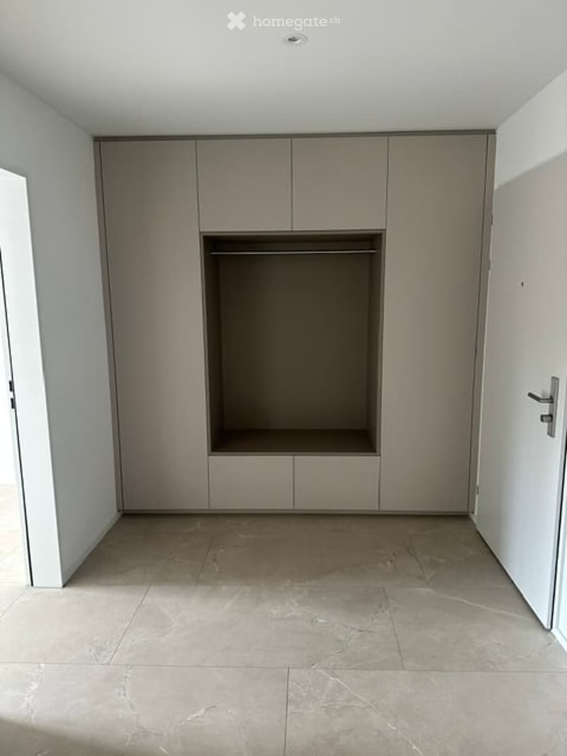 Empty room with built-in closet and tiled floor. No furniture or personal items present.