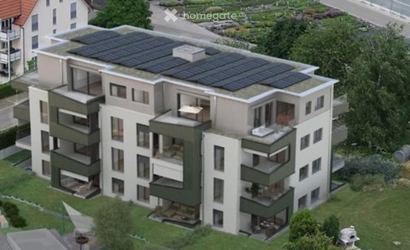 Multistory building, large solar panels on the roof, balconies, greenery in the area, multiple windows