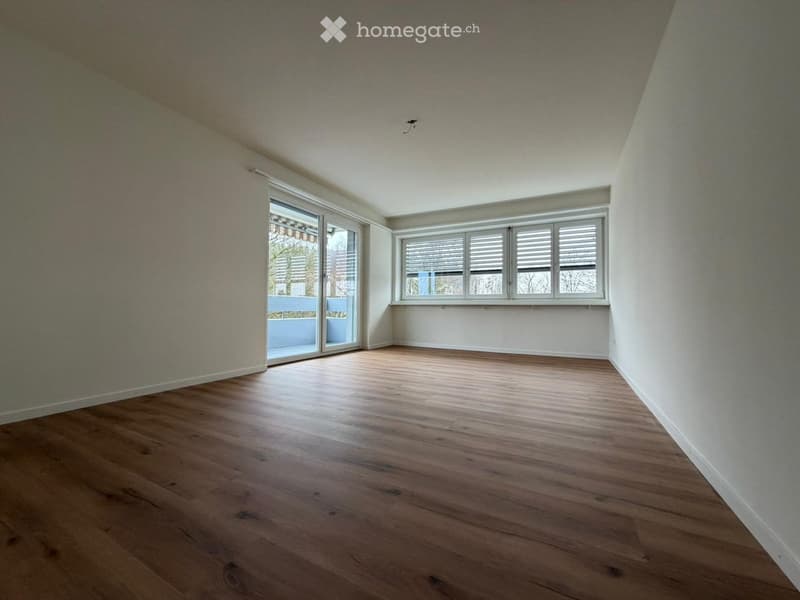 empty room, wooden floor, white walls, sliding glass doors, windows, balcony