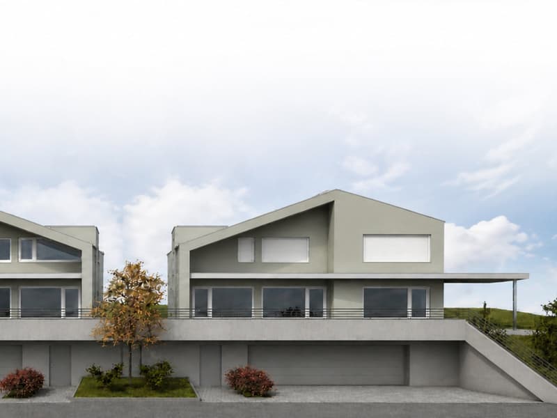 Modern two-story house with grey exterior, large windows, and a spacious balcony on the upper level. Features a raised ground floor with a garage and landscaped garden area.