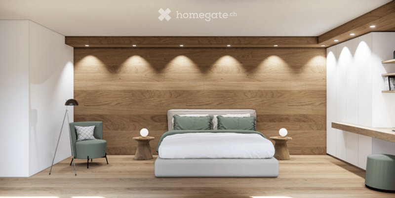 Modern bedroom with a large wooden wall, a white bed with green pillows, a green armchair, two nightstands with lamps, and a small shelf on the right side.