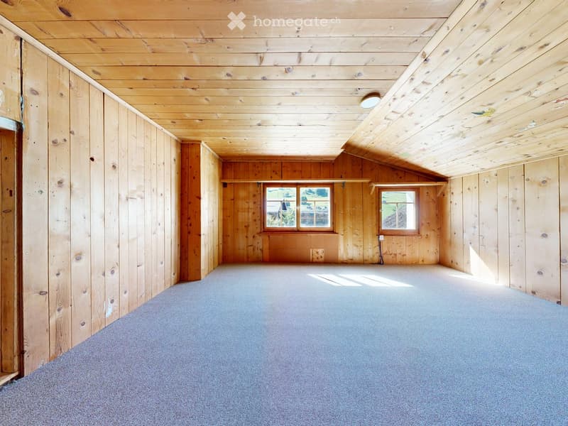 Empty room with wooden walls and ceiling, carpeted floor, two windows, and exposed wooden beams.