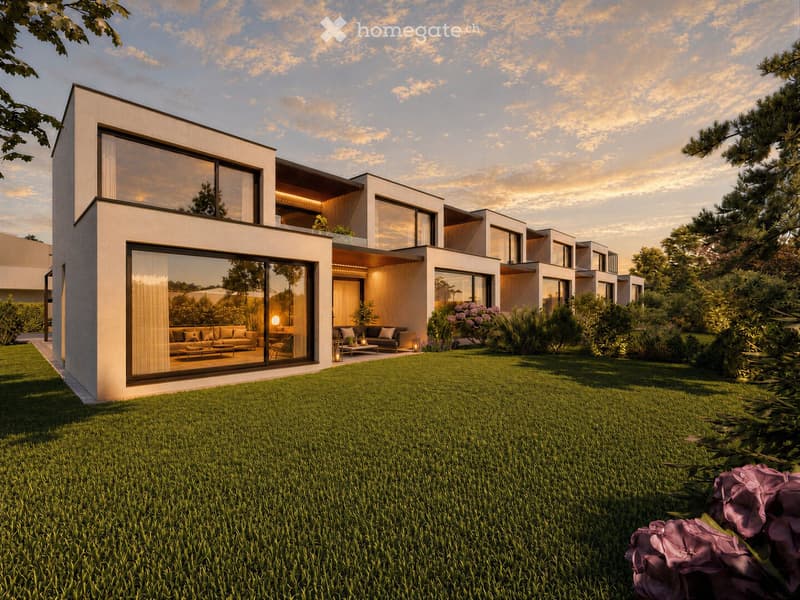 Modern two-story house with large glass windows, a well-maintained lawn, and surrounding greenery.