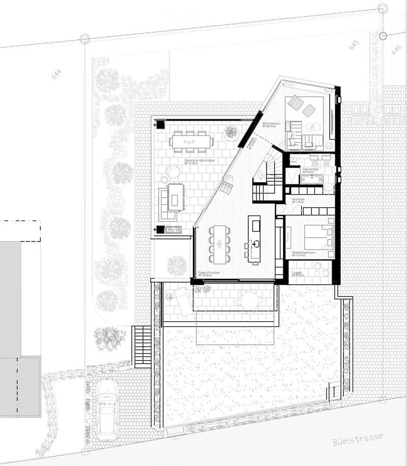 Floor plan of a house with multiple rooms including a living room, dining area, kitchen, bedrooms, bathrooms, and a garage. The layout includes a patio and outdoor seating area.