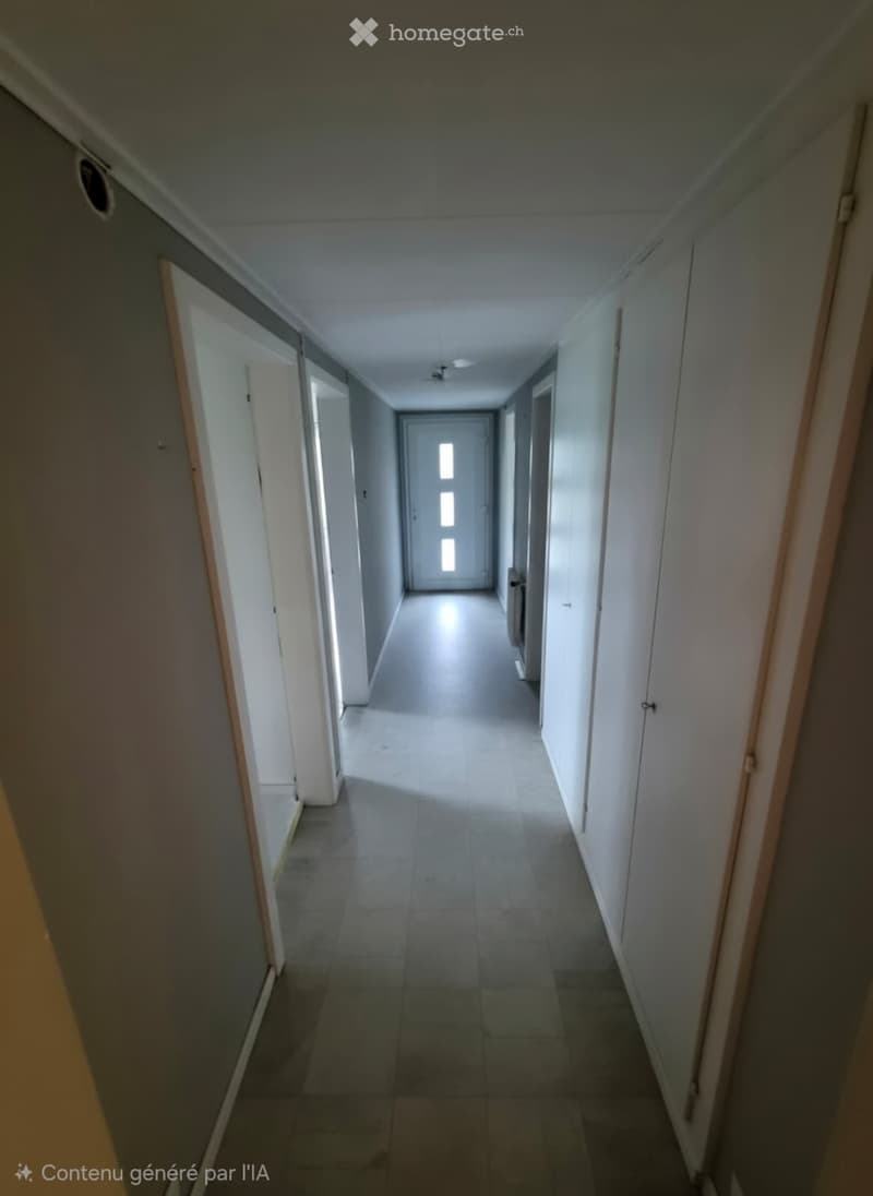 Empty hallway with tiled floor, white walls, and multiple doors on both sides.