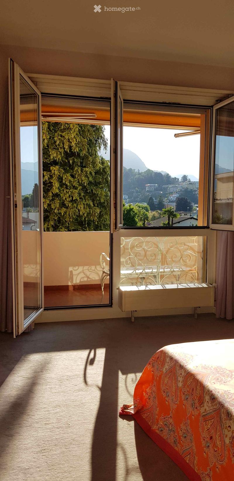 bedroom with balcony, large windows, carpeted floor, bed, view of mountains