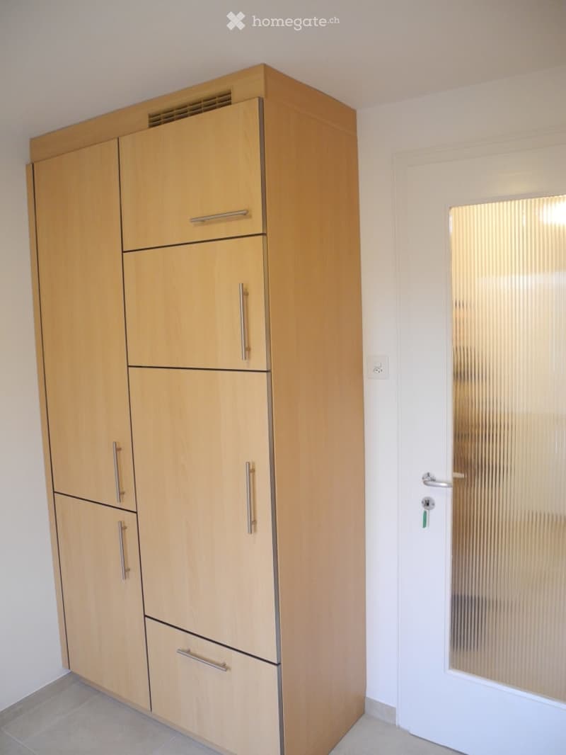 Large wooden wardrobe with multiple drawers and compartments