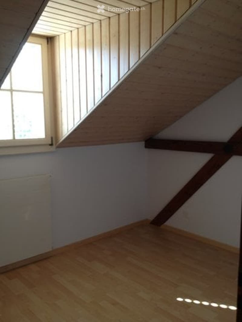 empty room, wooden floor, wooden beams, window, radiator