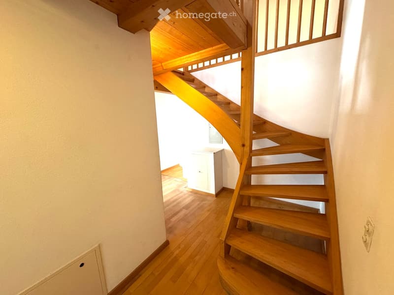 wooden staircase, wooden floor, white walls, white cabinet, power outlet