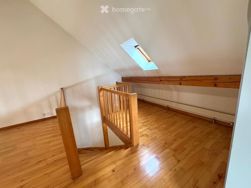 empty room, wooden floor, wooden staircase, white walls, skylight