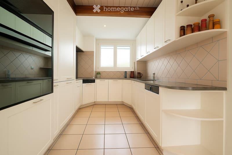 Modern kitchen with white cabinets, tiled backsplash, and stainless steel appliances including an oven and dishwasher. Features a central island with a sink and faucet, and decorative jars on an open shelf.